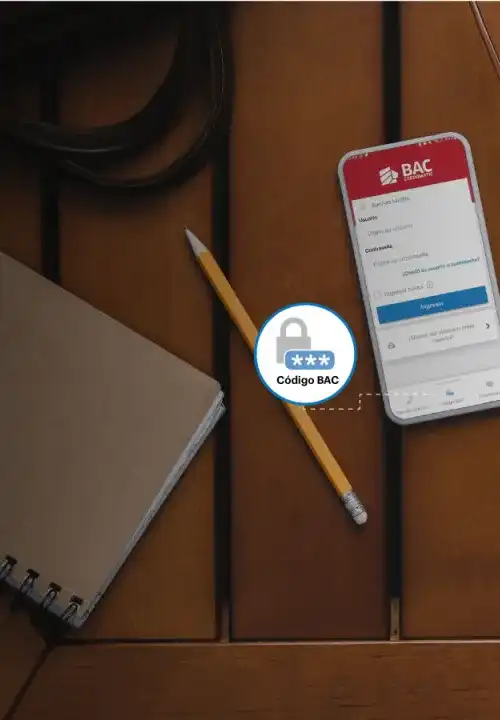 Vista superior de celular, café y libreta en un mesa, mostrando la pantalla de Ingreso de Banca Móvil, haciendo énfasis en Código BAC